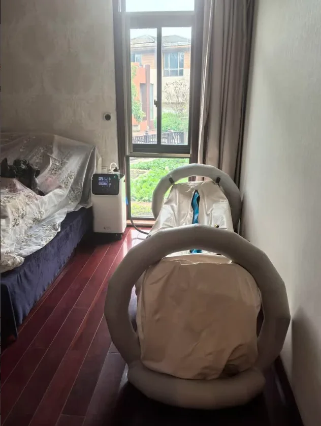 Air-frame hyperbaric chamber installed beside a home window