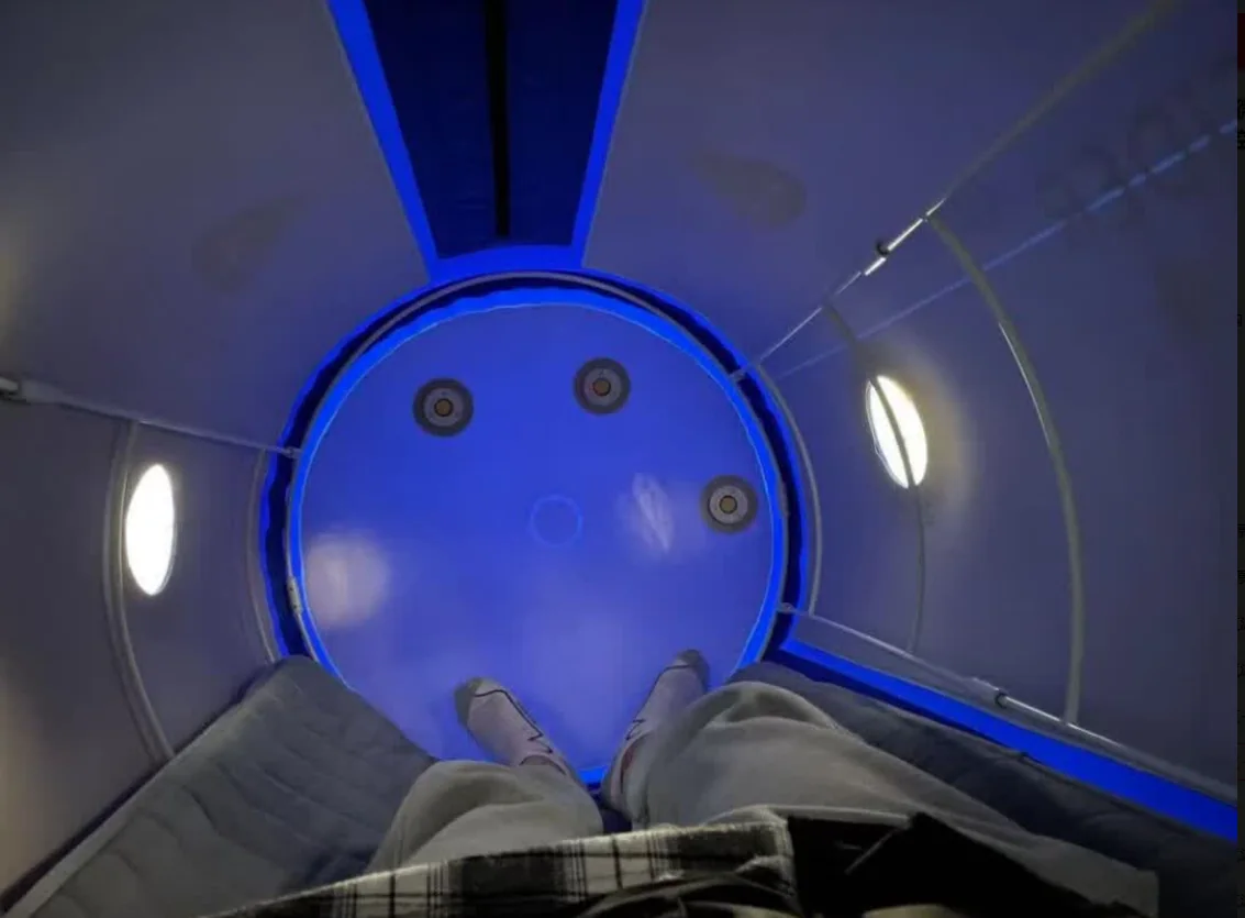 Blue illuminated interior of a CONSIDER lying chamber